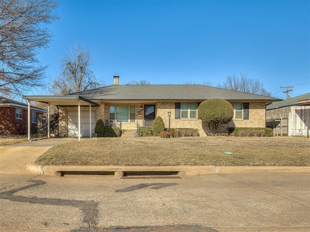 ranch-style house featuring a garage, a carport, a front yard, and covered porch