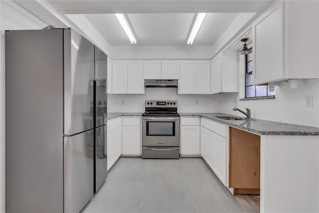 kitchen with white cabinetry, appliances with stainless steel finishes, sink, and light stone counters