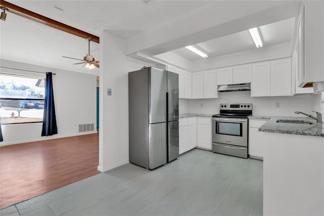 kitchen with white cabinetry, appliances with stainless steel finishes, light stone countertops, and sink