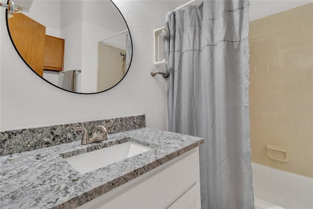 bathroom with vanity and shower / bath combo with shower curtain