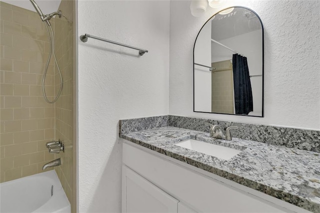 bathroom with shower / bath combination with curtain and vanity