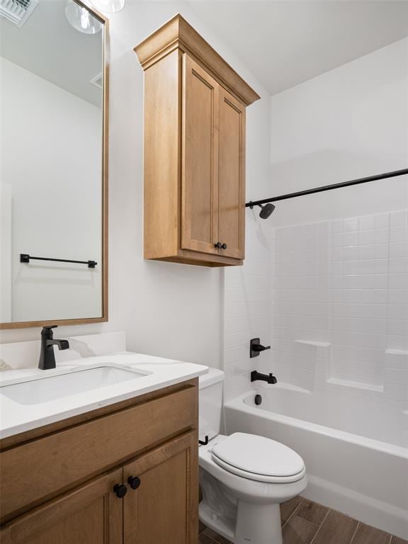 full bathroom with vanity, wood-type flooring, bathing tub / shower combination, and toilet