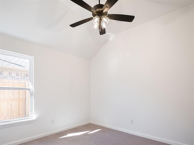 spare room with carpet floors, a wealth of natural light, and lofted ceiling