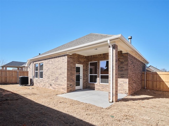 rear view of house featuring central AC unit and a patio