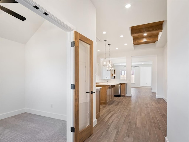 hall featuring sink and light wood-type flooring