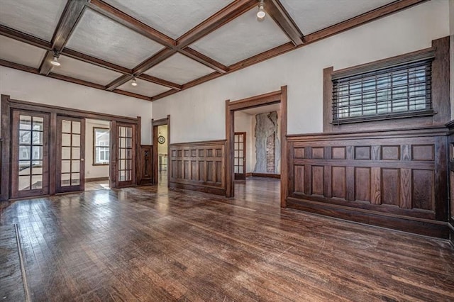 interior space with coffered ceiling, dark hardwood / wood-style floors, beamed ceiling, and french doors