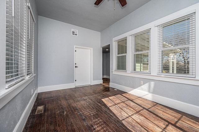 interior space with ceiling fan and dark hardwood / wood-style flooring