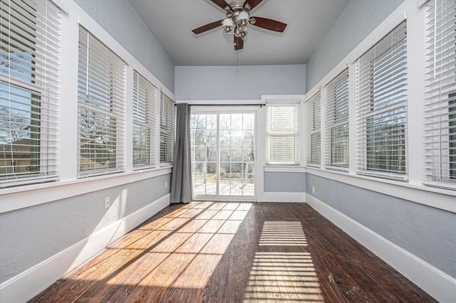 unfurnished sunroom with ceiling fan