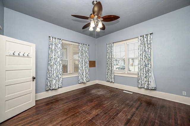 unfurnished room with hardwood / wood-style flooring, ceiling fan, and a healthy amount of sunlight