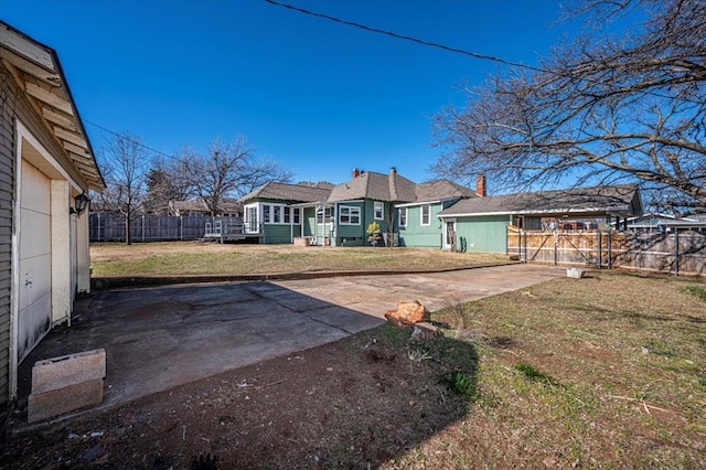 rear view of house with a patio area and a lawn