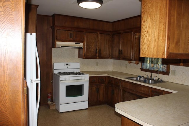 kitchen with white appliances, sink, and backsplash