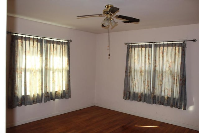 empty room featuring dark hardwood / wood-style flooring and ceiling fan