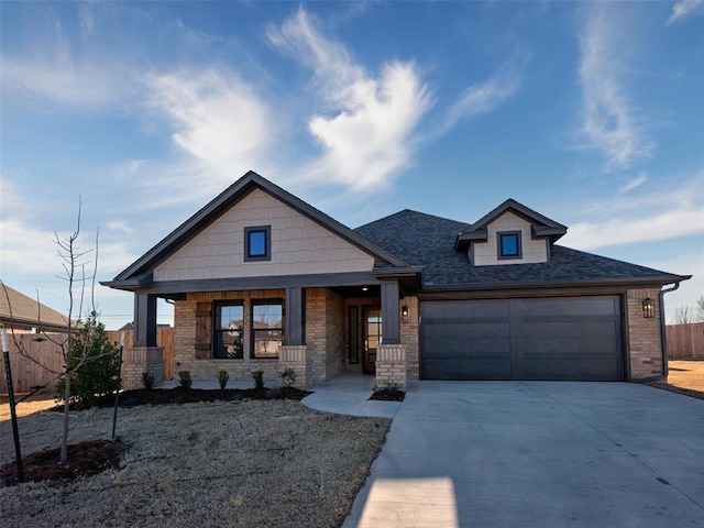 craftsman-style house with driveway, brick siding, an attached garage, and fence