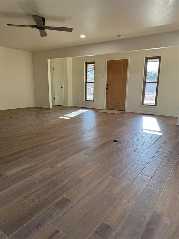 unfurnished room featuring hardwood / wood-style flooring and ceiling fan