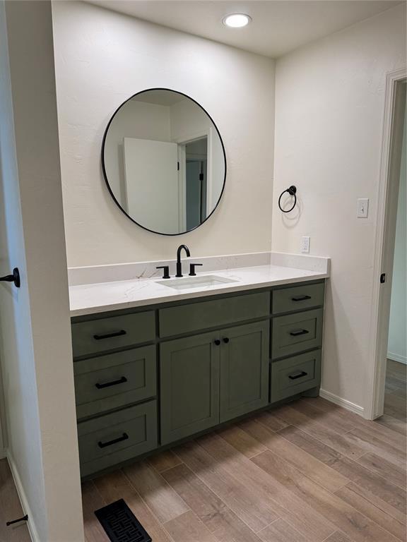 bathroom with hardwood / wood-style flooring and vanity