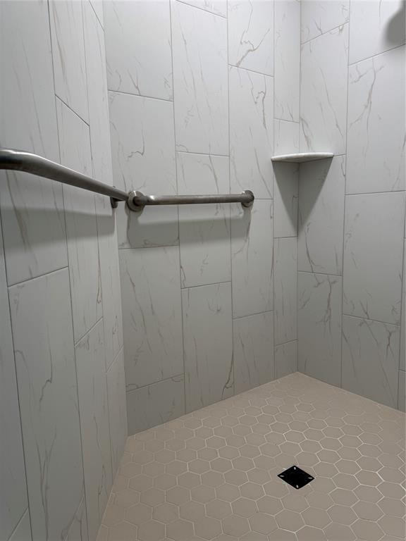 bathroom with a tile shower