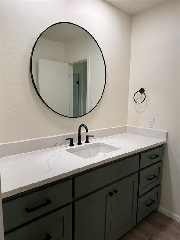 bathroom with vanity and hardwood / wood-style floors