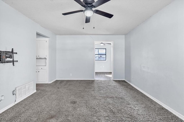 carpeted spare room featuring a textured ceiling