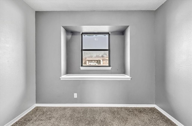 empty room featuring carpet floors and a textured ceiling