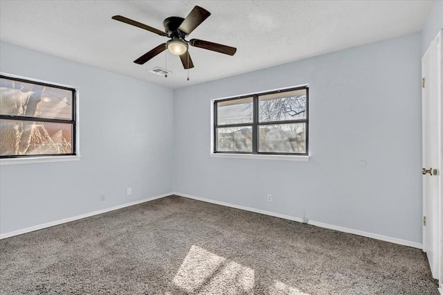 carpeted empty room featuring ceiling fan