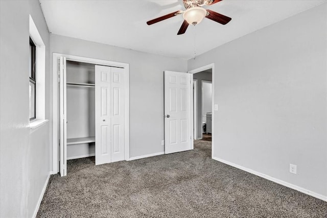 unfurnished bedroom with dark carpet, ceiling fan, and a closet