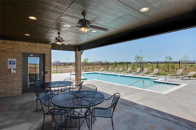 view of swimming pool with ceiling fan and a patio area