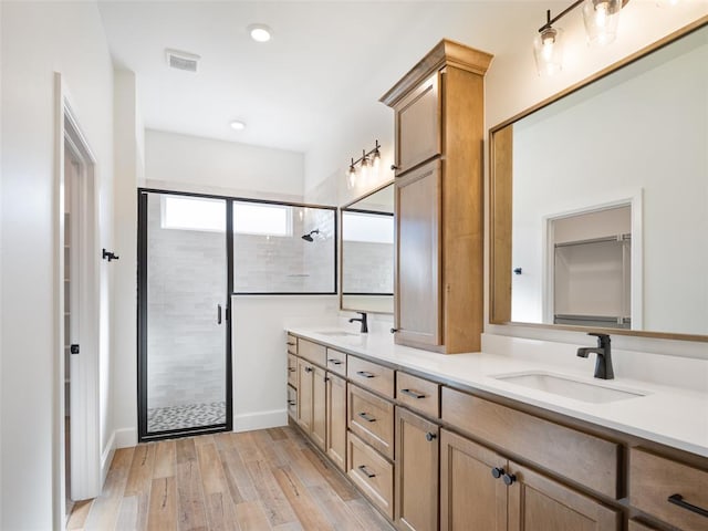 bathroom with vanity, an enclosed shower, and hardwood / wood-style floors