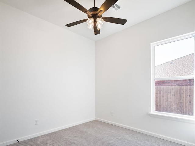 carpeted empty room featuring ceiling fan