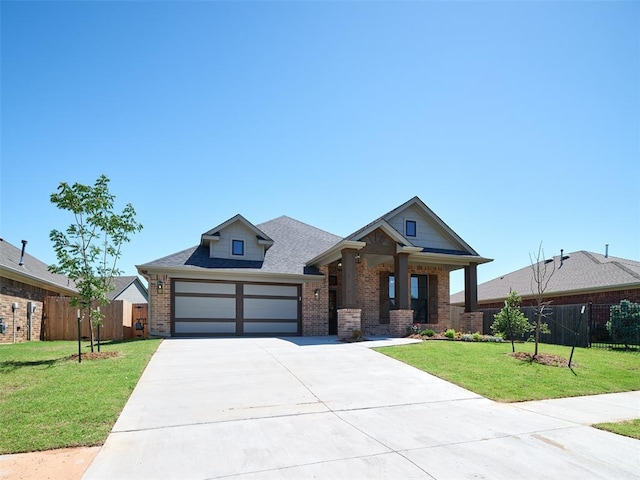 2524 NW 179th St, Edmond, OK 73012 - view of front of house with brick siding, driveway, a garage, and covered porch