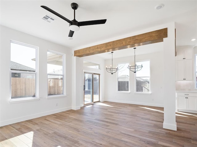 2524 NW 179th St, Edmond, OK 73012 - unfurnished living room featuring light wood finished floors, a chandelier, baseboards, ceiling fan, and beamed ceiling