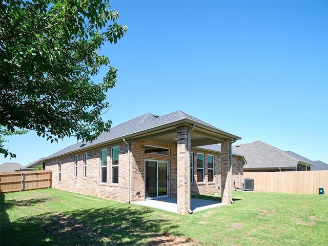 2524 NW 179th St, Edmond, OK 73012 - rear view of house featuring brick siding, cooling unit, a patio, and roof with shingles
