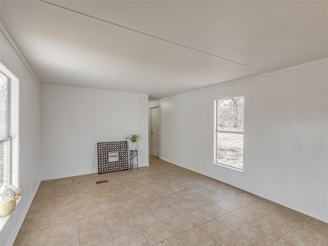 tiled empty room featuring crown molding