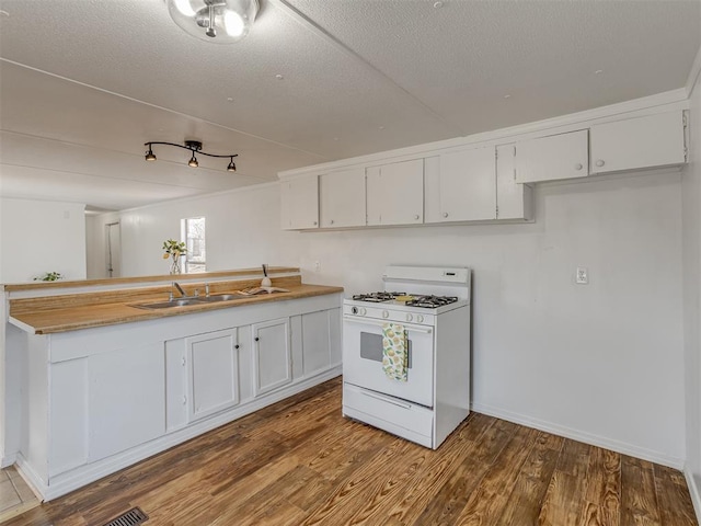 kitchen with white cabinetry, sink, hardwood / wood-style flooring, gas range gas stove, and a textured ceiling