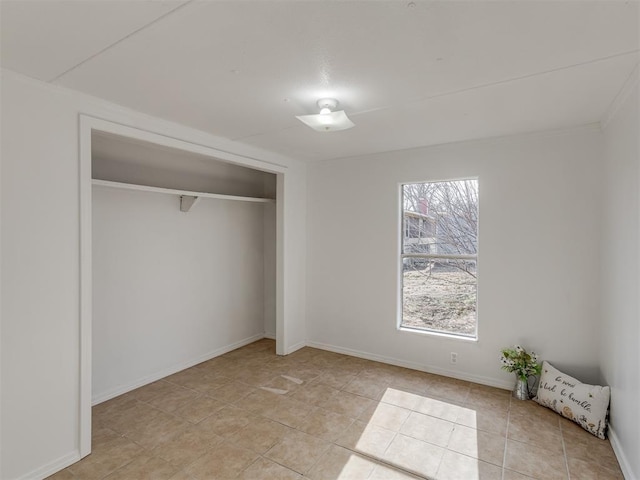 unfurnished bedroom with light tile patterned floors and a closet