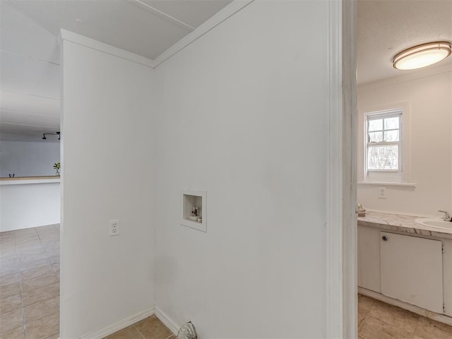 laundry area with washer hookup, sink, and ornamental molding