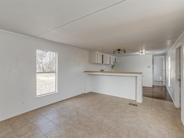 interior space featuring visible vents and crown molding