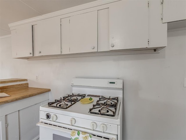 kitchen featuring white gas range oven, white cabinetry, and light countertops