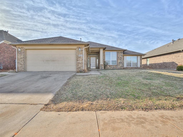 view of front of home featuring a garage and a front lawn