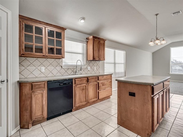 kitchen featuring lofted ceiling, sink, a center island, black dishwasher, and decorative light fixtures