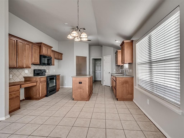 kitchen with a kitchen island, lofted ceiling, sink, light tile patterned floors, and black appliances