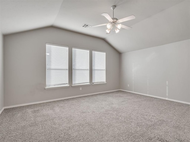 carpeted spare room with lofted ceiling and ceiling fan