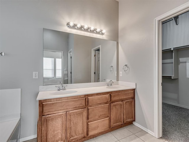 bathroom with vanity, a bath, and tile patterned flooring