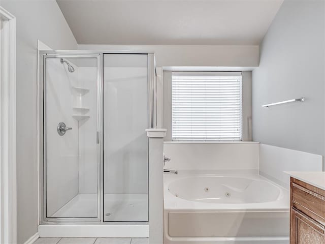 bathroom featuring tile patterned floors, vanity, and plus walk in shower