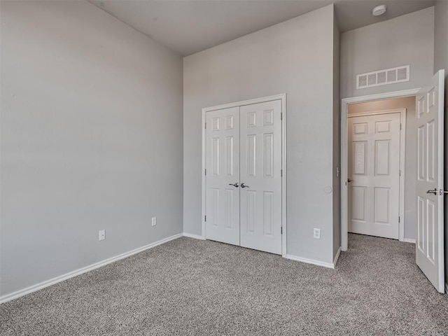 unfurnished bedroom featuring a closet and carpet