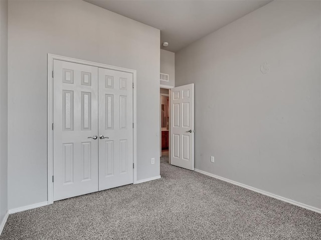 unfurnished bedroom featuring carpet floors and a closet