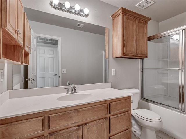 full bathroom with enclosed tub / shower combo, vanity, toilet, and tile patterned flooring