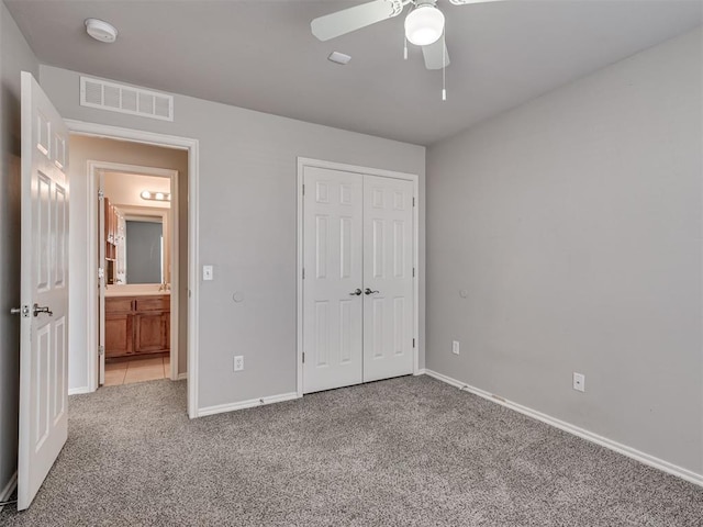 unfurnished bedroom featuring ceiling fan, carpet flooring, and a closet