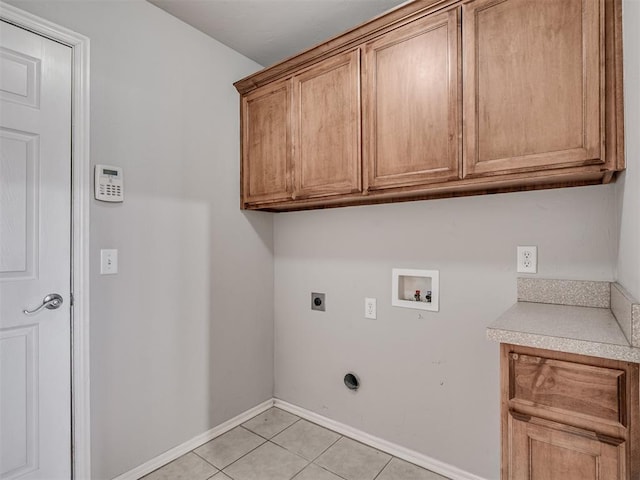 clothes washing area featuring light tile patterned floors, hookup for a washing machine, cabinets, and hookup for an electric dryer