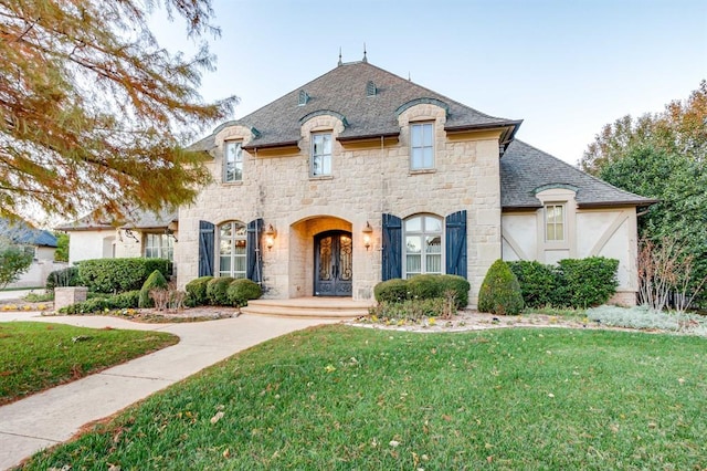 french country style house featuring a front yard