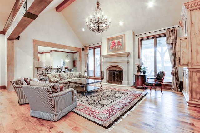 living room featuring high vaulted ceiling, beam ceiling, light hardwood / wood-style floors, and a chandelier